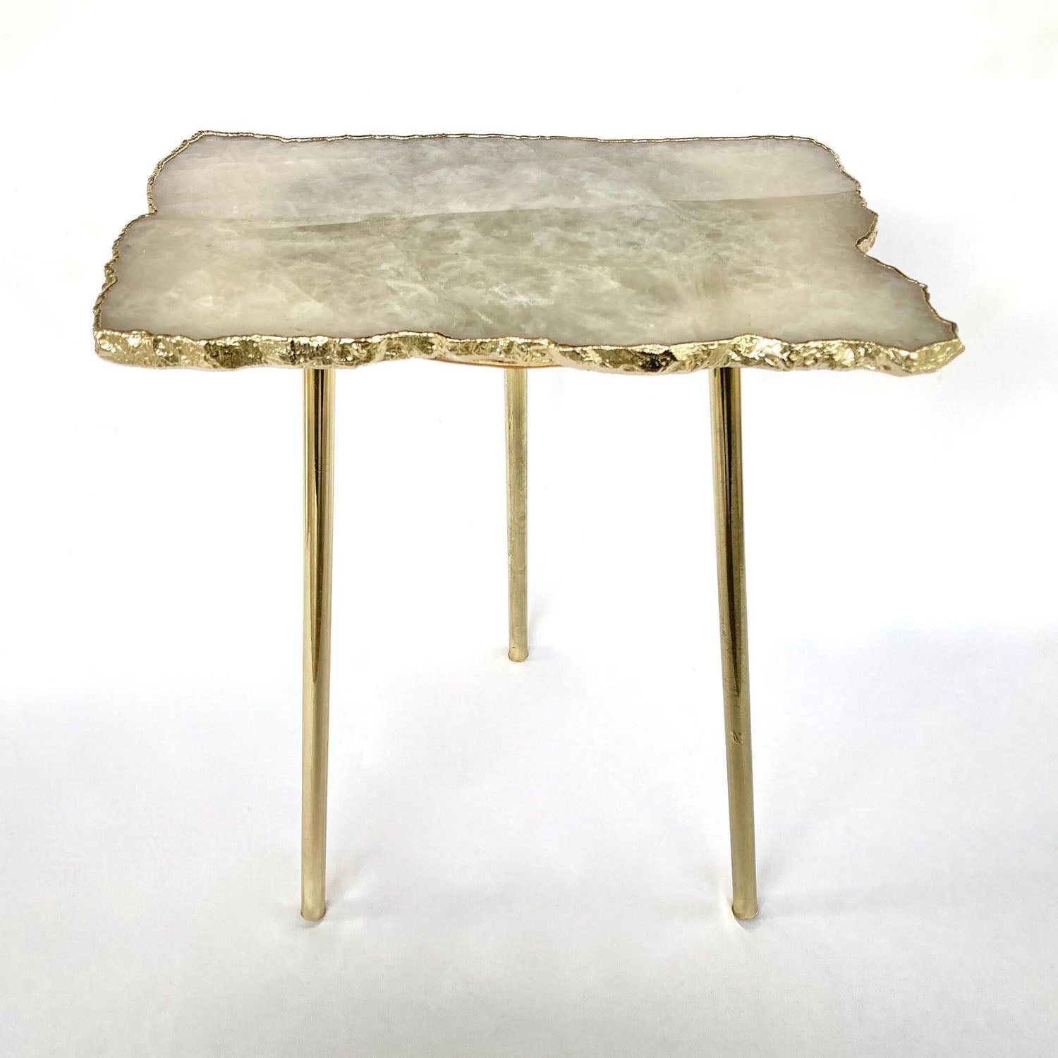 Table with a stone-like top and gold legs 